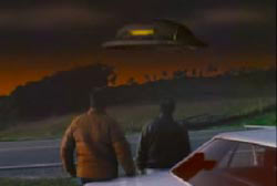 Two men outside of their car looking at a UFO hover over the horizon 