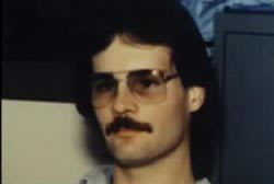 Danny Williams with a mustach and glasses