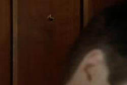 A bullet hole in the wall behind Danny 