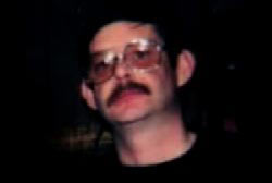 Dave Bocks with a mustache and glasses