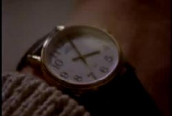 A gold and black leather watch on Phi's wrist that read 4am
