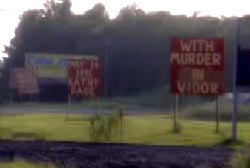 Signs errected near the site of the accident to commemorate the death of Kathy Page