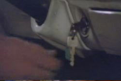 A man reaching for keys in a cars ignition