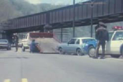 The blue car being towed by police