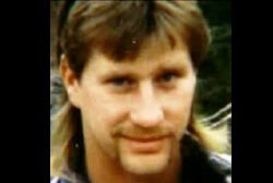 Smiling Tom Kueter with a mullet and mustache