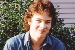 Smiling Tommy Burkett with curly brown hair