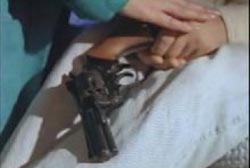 A revolver resting in Tommy's hands