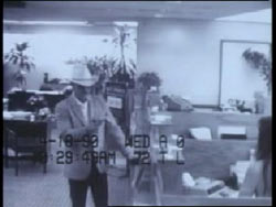 Securty footage of the bandit holding up a bank with a cowboy hat on