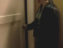 Teresa opening the door to a secret room 