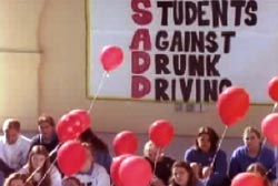Students holding red balloons at a Students Against Drunk Driving rally