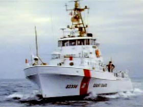 A white and red coast guard boat on the ocean