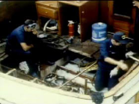 Agents removing the floorboards of Penalver's boat to find bags of cocain