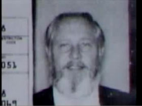 Quinns drivers license with a photo of him with a dull grey/white beard