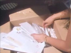 Caroline digging through a carboard box filled with unexplained mortgage payments