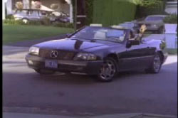 Kern waving from the driver seat of his expensive mercedes convertible