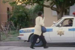 C.W. Roddy approaching an officer in a police cruiser