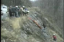 Search party recovering Sherry Hart's body from the bottom of a cliff