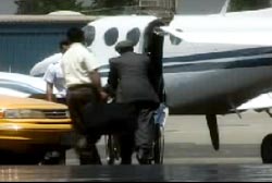 Solis and pilot carrying bags onto a private jet