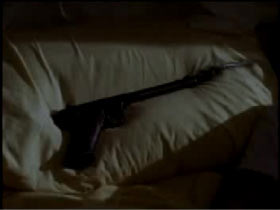 Pistol laying across a pillow