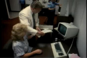 Two police investigators holding Woody's bank records by a computer